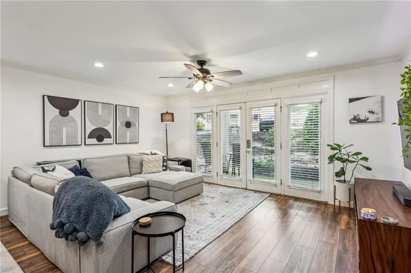 a living room with furniture and wooden floor