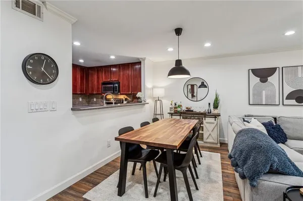 a view of a kitchen with granite countertop a table and chairs in it