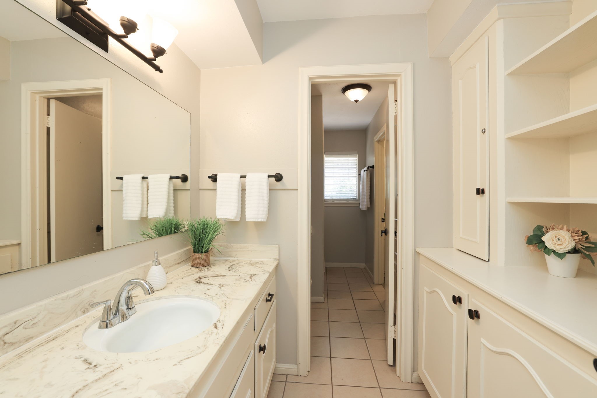 22010 Buescher Road Tomball, TX 77377 - Photo 13 of 30 a spacious bathroom with a double vanity sink mirror and shower