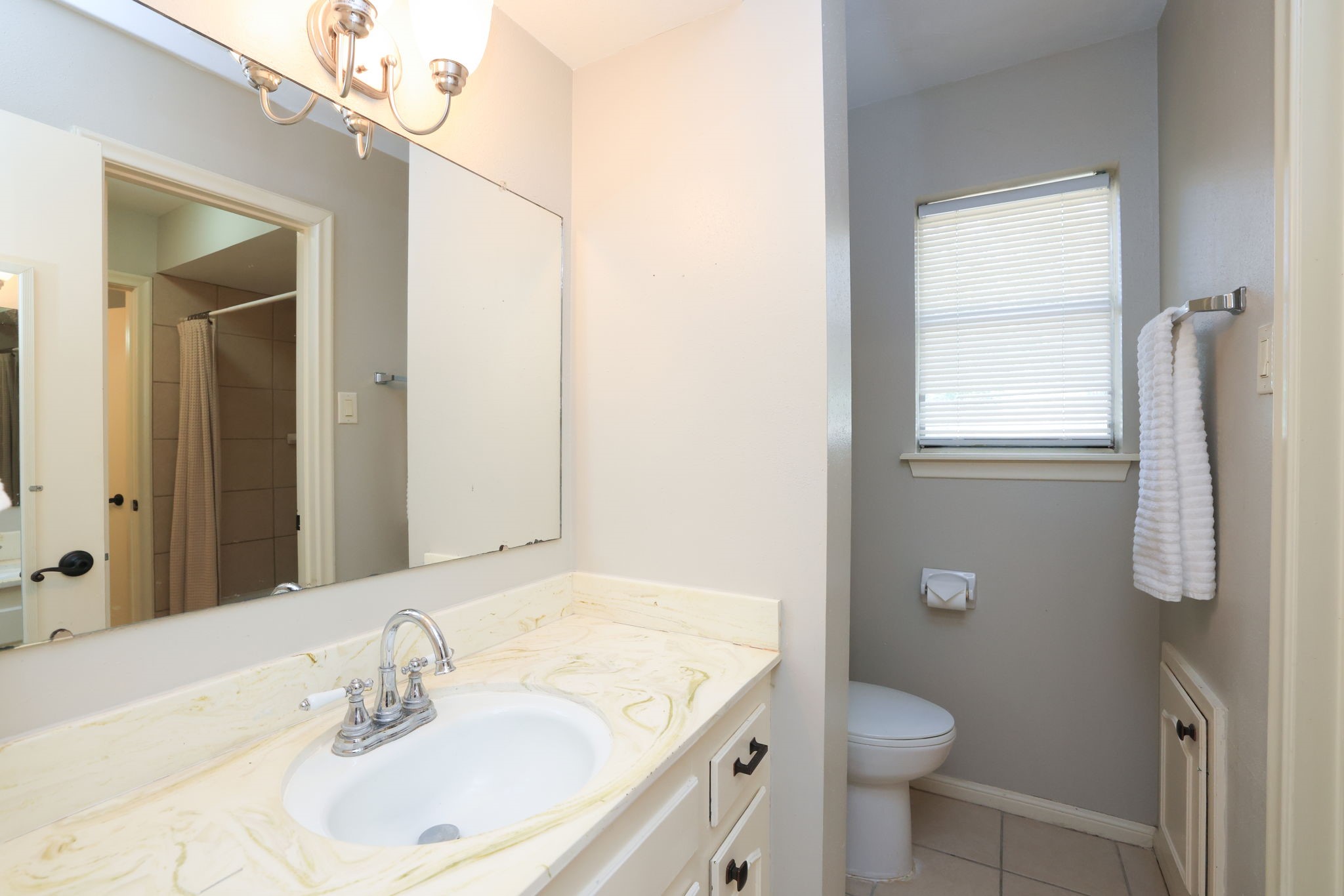 22010 Buescher Road Tomball, TX 77377 - Photo 15 of 30 a bathroom with a sink toilet and mirror