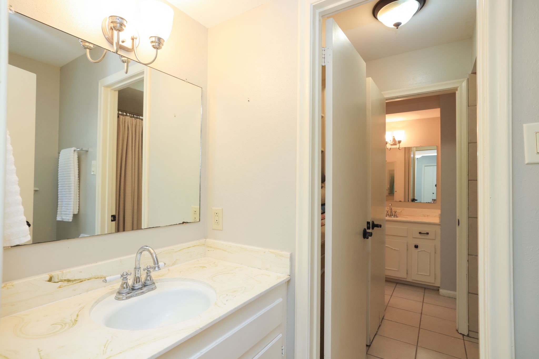 22010 Buescher Road Tomball, TX 77377 - Photo 16 of 30 a bathroom with a sink vanity and a mirror