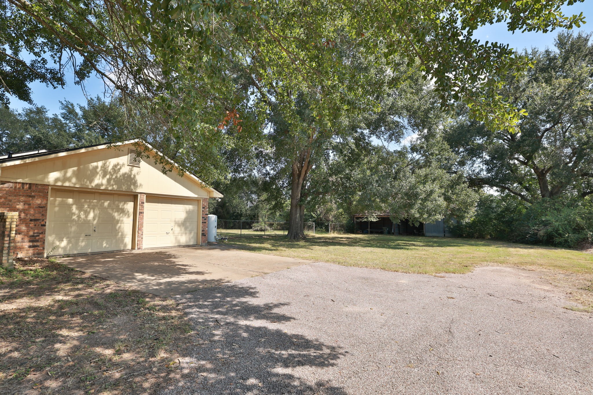 22010 Buescher Road Tomball, TX 77377 - Photo 21 of 30 a view of a house with a yard and large trees