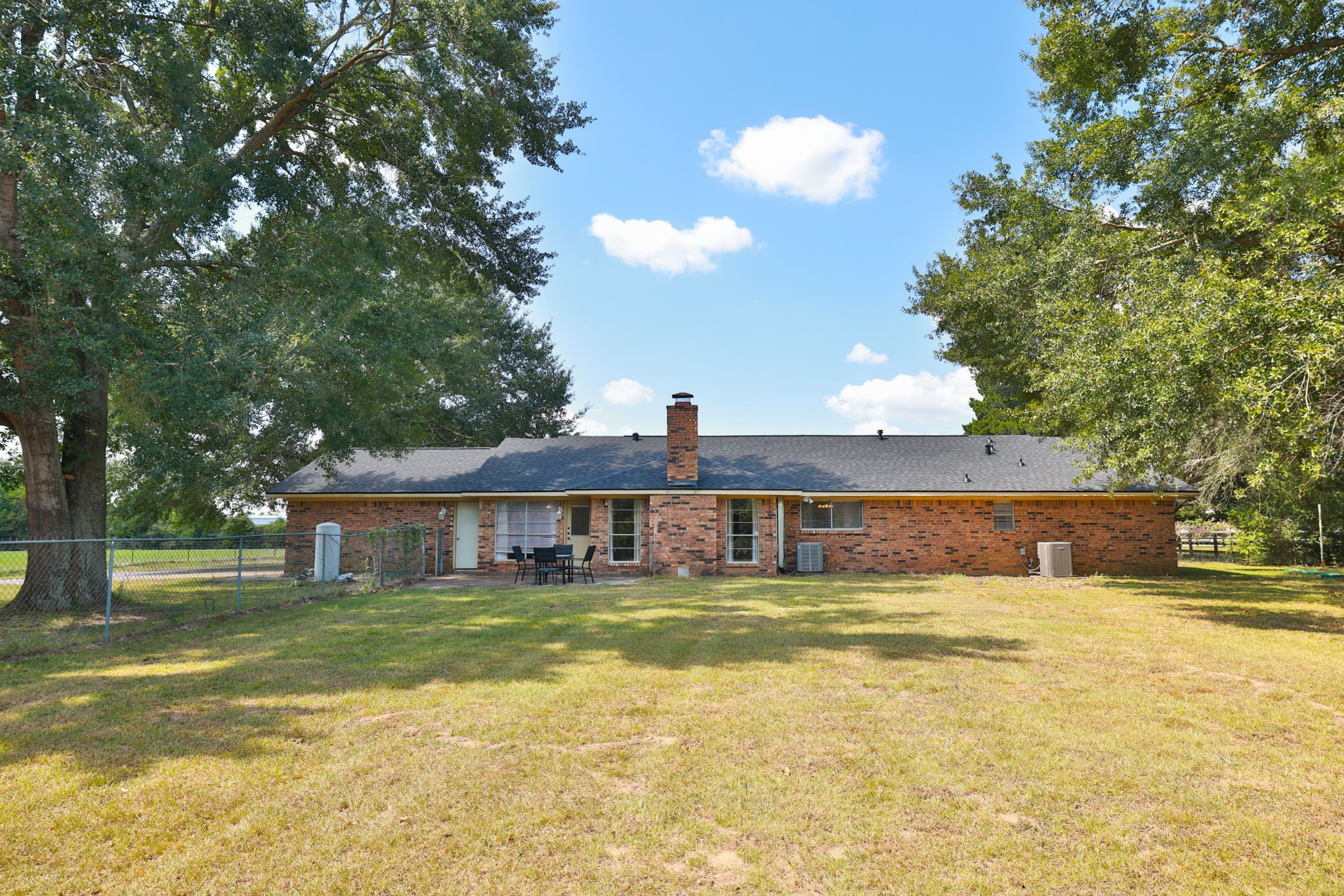 22010 Buescher Road Tomball, TX 77377 - Photo 22 of 30 a view of a swimming pool in front of house