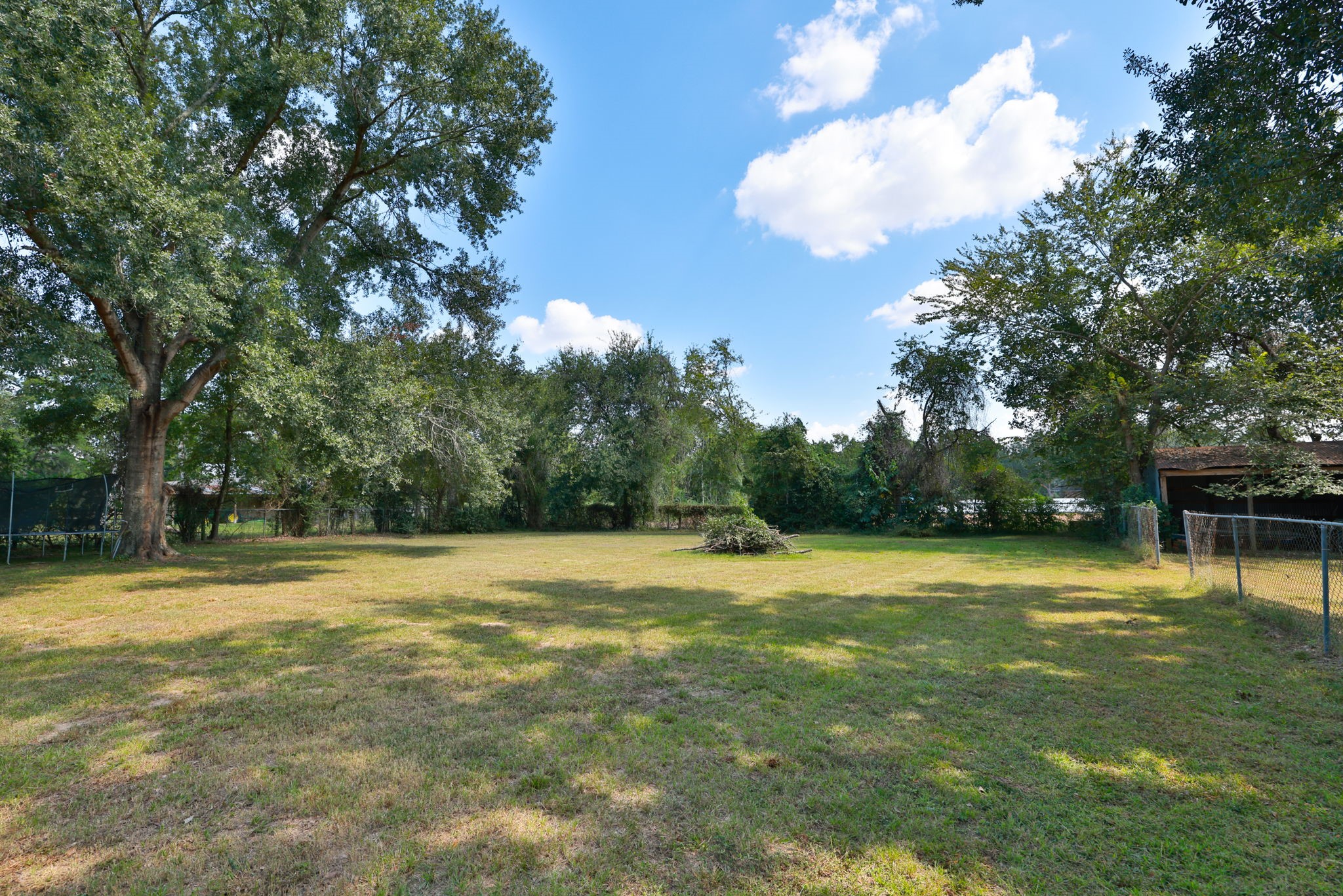 22010 Buescher Road Tomball, TX 77377 - Photo 23 of 30 a swimming pool with trees in the background