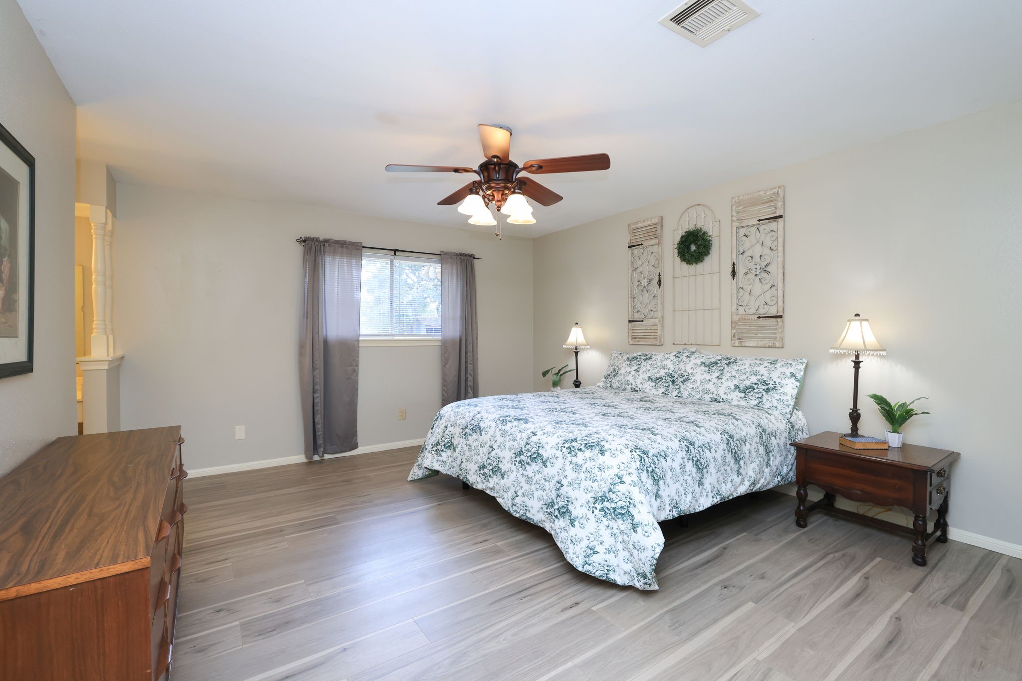 22010 Buescher Road Tomball, TX 77377 - Photo 10 of 30 a bedroom with a bed and a chandelier