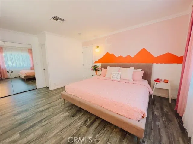 a bedroom with a bed and a potted plant