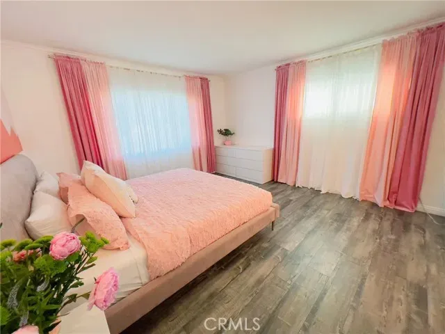 a bedroom with a bed dresser and a window