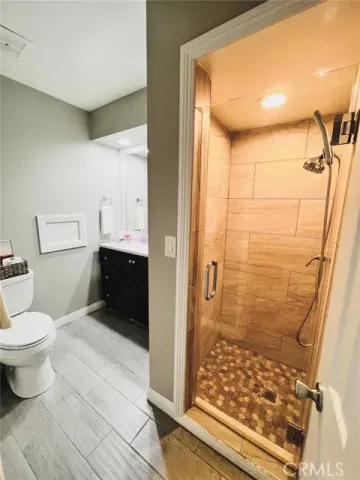 a bathroom with a toilet and a shower