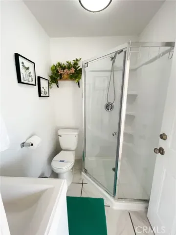 a bathroom with a toilet and a shower