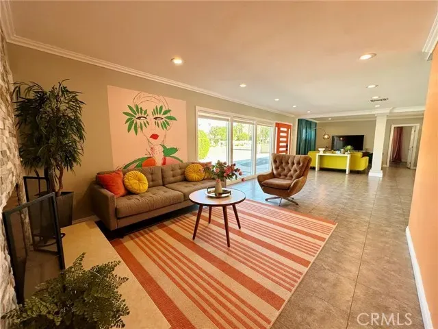 a living room with furniture a couch and a potted plant