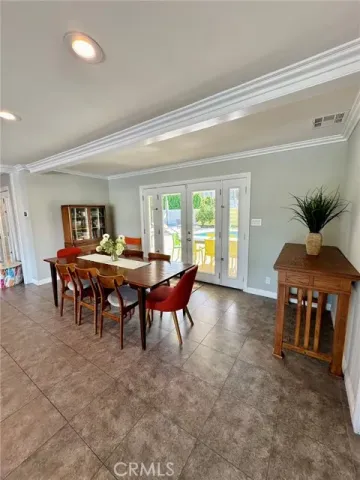 a view of a dining room with furniture and a potted plant