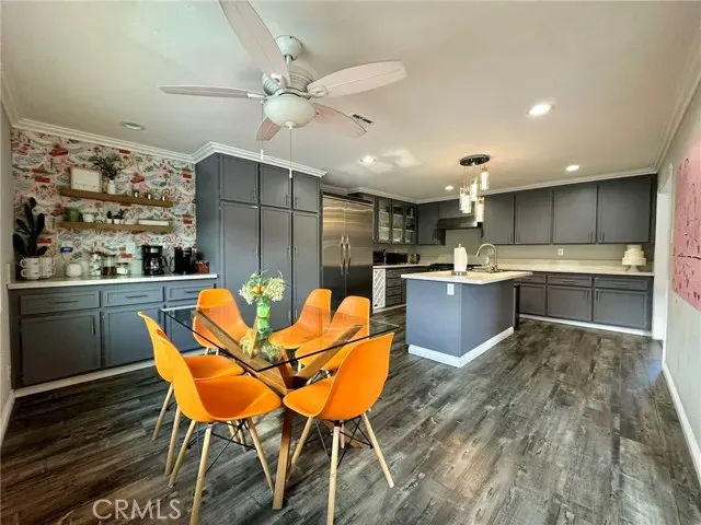 a kitchen with stainless steel appliances kitchen island granite countertop a sink and cabinets