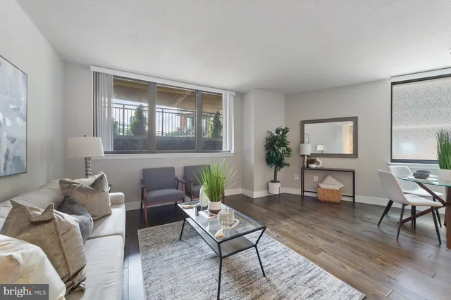 a living room with furniture and wooden floor