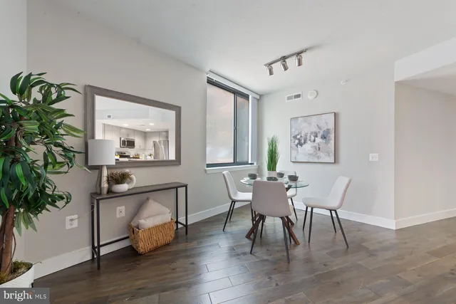 a view of a dining room with furniture window and wooden floor