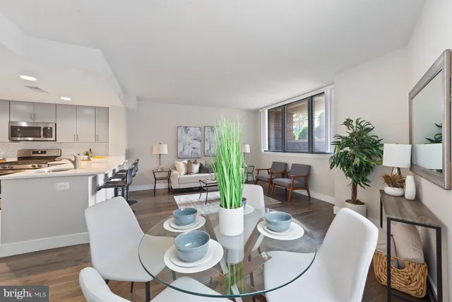 a dining room with furniture a window and wooden floor
