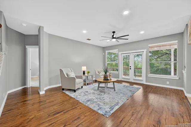 a living room with furniture and wooden floor