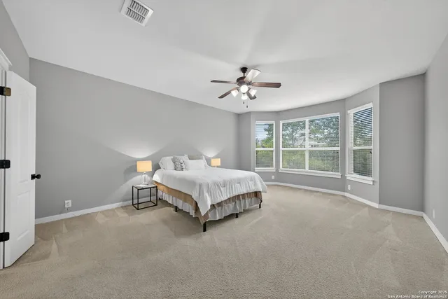 a spacious bedroom with a bed and a window