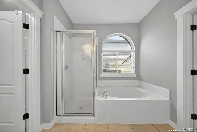 a bathroom with bathtub and a shower