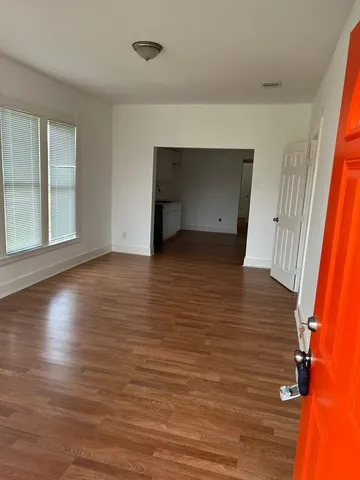 wooden floor in an empty room with a window