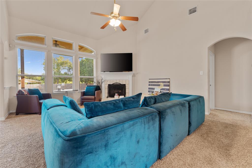 5533 Wisdom Court Waco, TX 76708 - Photo 12 of 21 a living room with furniture a flat screen tv and a fireplace