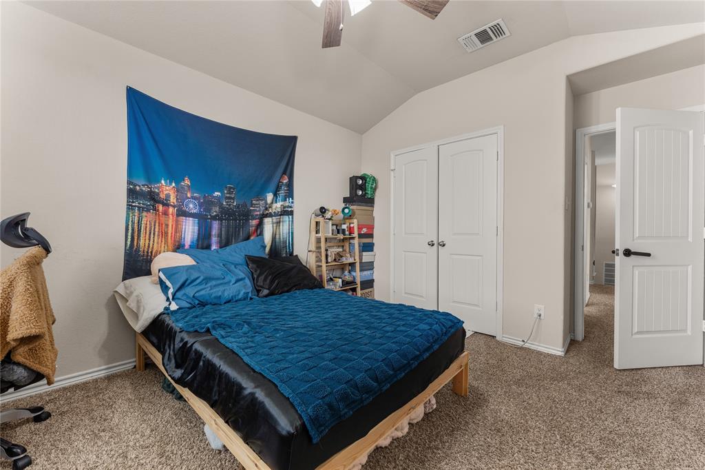 5533 Wisdom Court Waco, TX 76708 - Photo 18 of 21 a bedroom with a bed and chandelier
