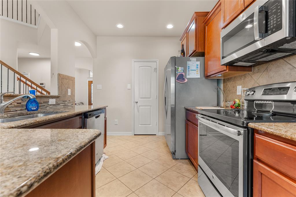 5533 Wisdom Court Waco, TX 76708 - Photo 9 of 21 a kitchen with stainless steel appliances granite countertop a sink a stove and a refrigerator