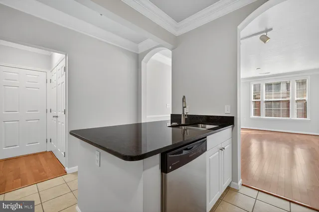 a kitchen with stainless steel appliances granite countertop a sink and a stove