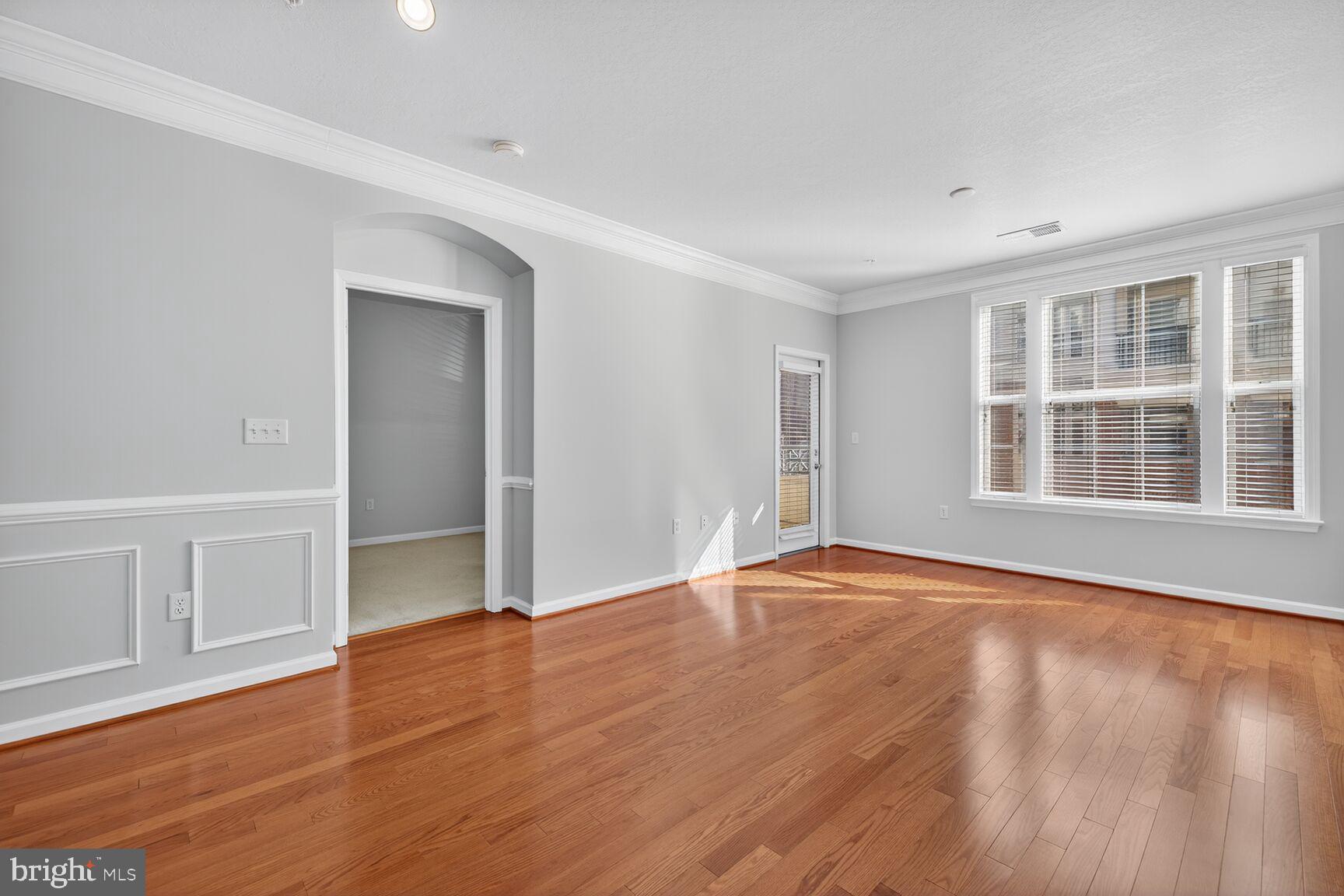 7 Granite Place, Unit 215 Gaithersburg, MD 20878 - Photo 16 of 36 wooden floor in an empty room with a window