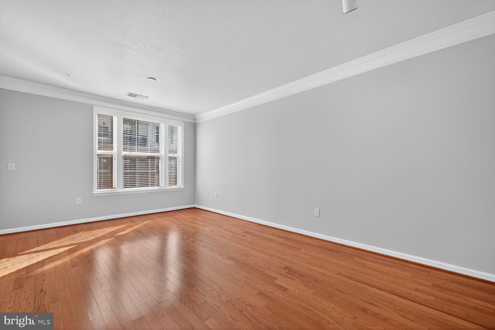 7 Granite Place, Unit 215 Gaithersburg, MD 20878 - Photo 17 of 36 wooden floor in an empty room with a window