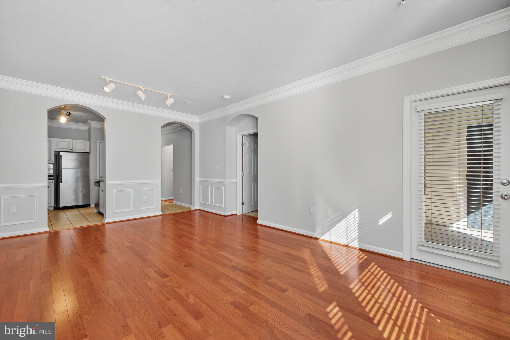 7 Granite Place, Unit 215 Gaithersburg, MD 20878 - Photo 19 of 36 a view of empty room with wooden floor and window