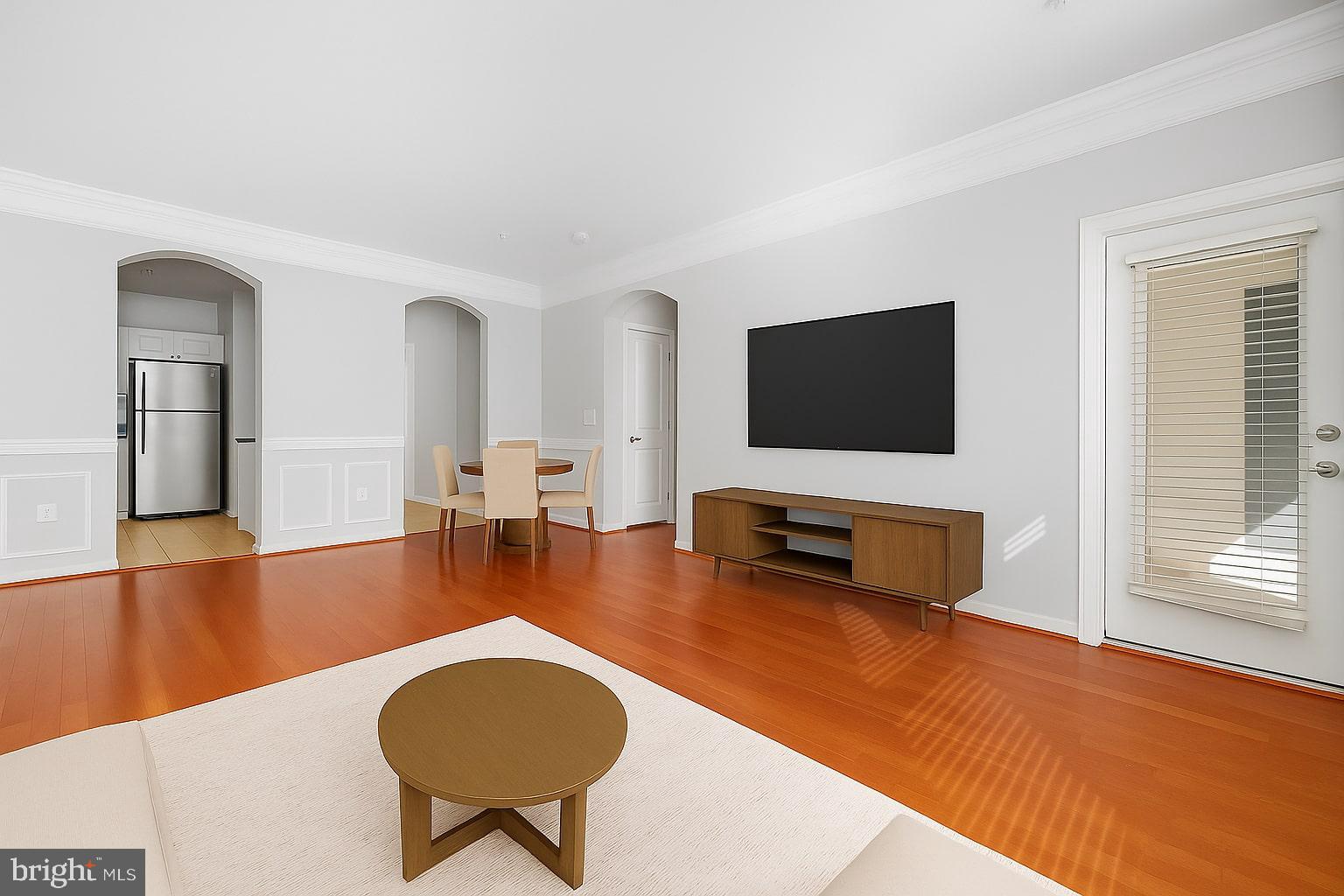 7 Granite Place, Unit 215 Gaithersburg, MD 20878 - Photo 2 of 36 a living room with furniture and a flat screen tv