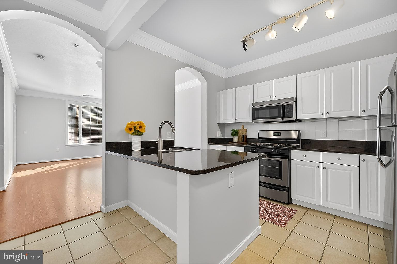 7 Granite Place, Unit 215 Gaithersburg, MD 20878 - Photo 4 of 36 a kitchen with stainless steel appliances granite countertop a sink and a stove