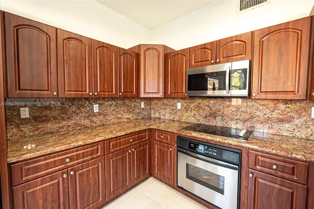 a view of a hallway with wooden floor and a bathroom