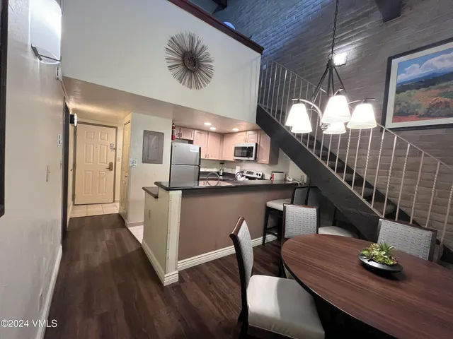 a dining room with furniture and wooden floor
