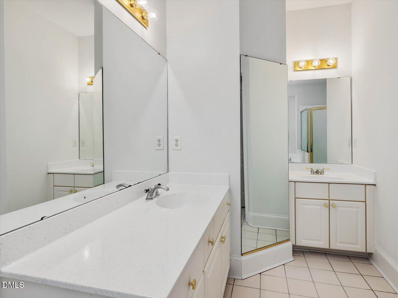 2721 Glassman Lane Raleigh, NC 27606 - Photo 12 of 26 a bathroom with a sink and a mirror