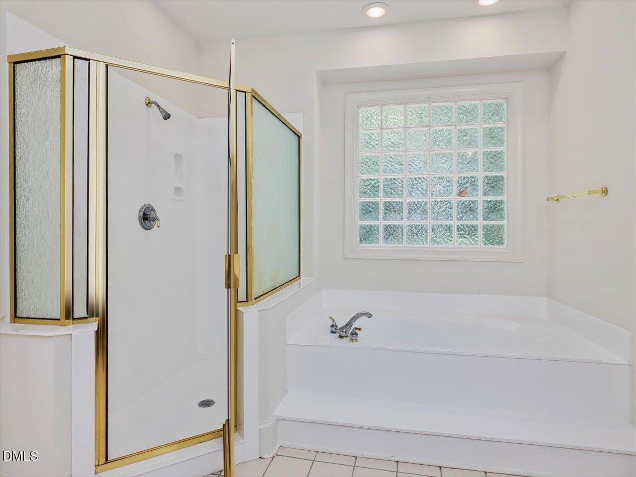 2721 Glassman Lane Raleigh, NC 27606 - Photo 13 of 26 a bathroom with a bathtub and a shower