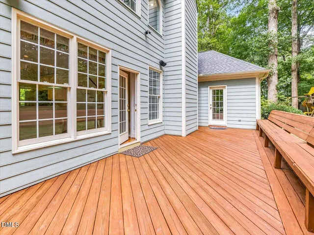 a view of backyard with a balcony and wooden floor