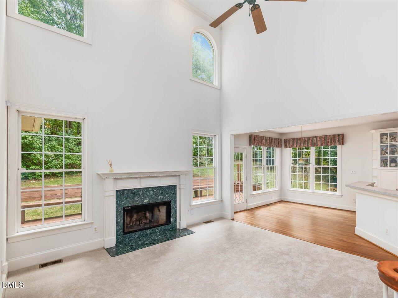 2721 Glassman Lane Raleigh, NC 27606 - Photo 2 of 26 a view of a livingroom with a fireplace and large windows
