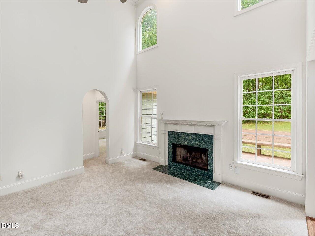2721 Glassman Lane Raleigh, NC 27606 - Photo 3 of 26 an empty room with windows and fireplace