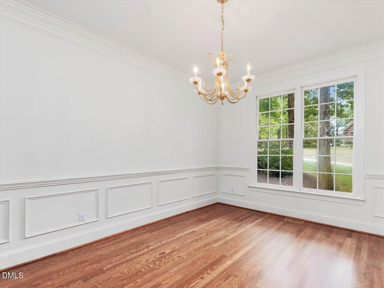 2721 Glassman Lane Raleigh, NC 27606 - Photo 6 of 26 a view of empty room with wooden floor and fan