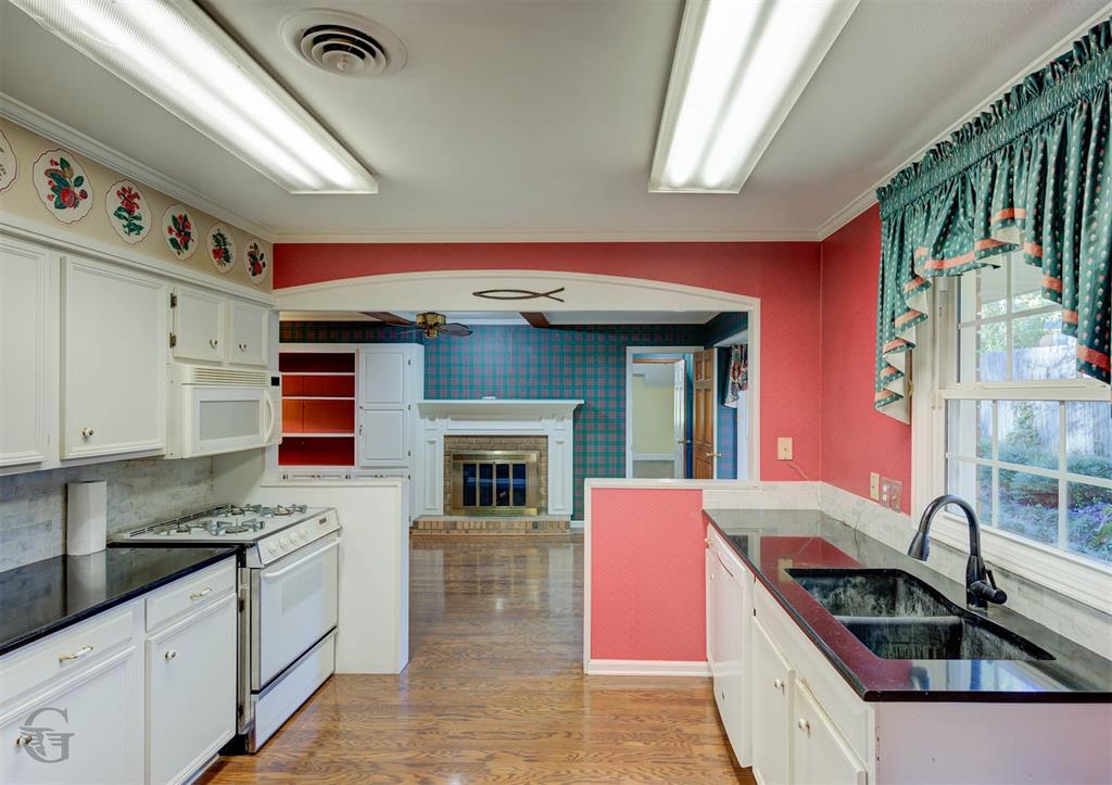 1306 East Todd Street Minden, LA 71055 - Photo 11 of 27 a kitchen with stainless steel appliances granite countertop a stove and a sink