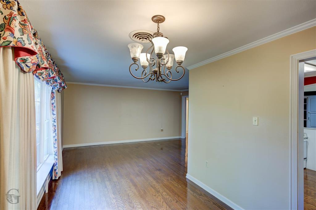 1306 East Todd Street Minden, LA 71055 - Photo 14 of 27 a view of a hallway with chandelier wooden floor and a chandelier
