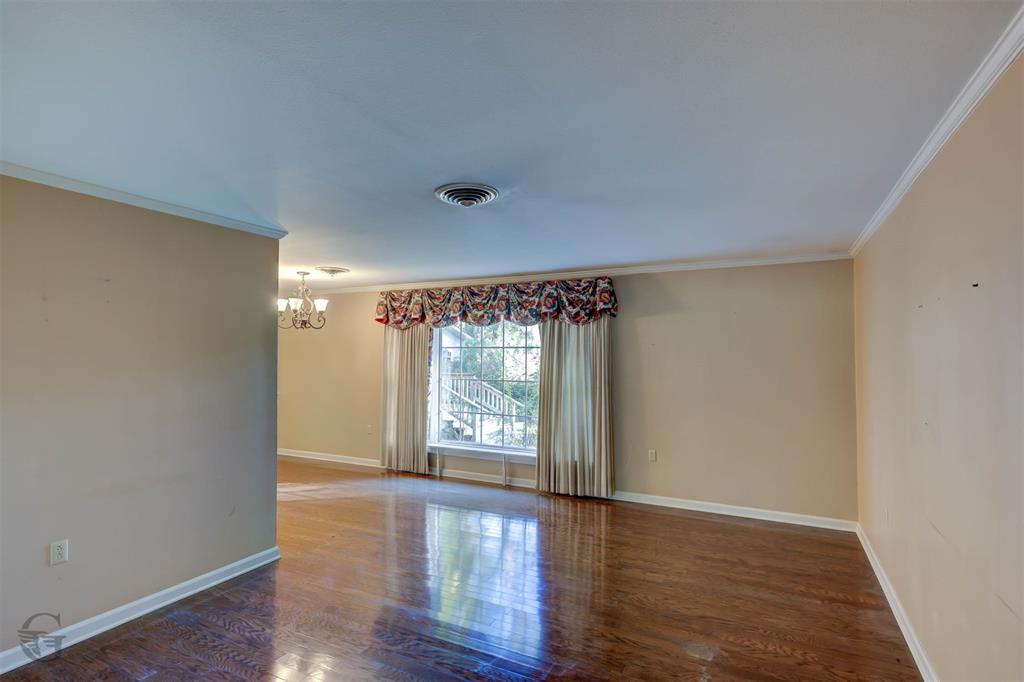 1306 East Todd Street Minden, LA 71055 - Photo 15 of 27 wooden floor in an empty room with a window