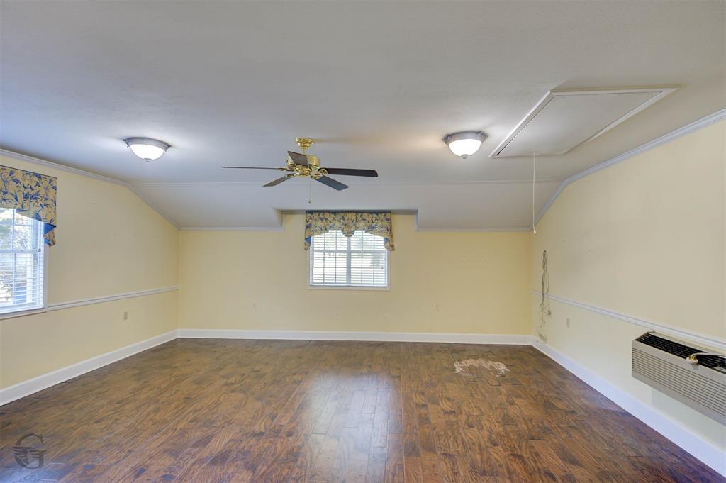 1306 East Todd Street Minden, LA 71055 - Photo 18 of 27 wooden floor in an empty room with a window