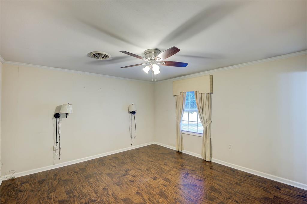 1306 East Todd Street Minden, LA 71055 - Photo 19 of 27 a view of an empty room with window and chandelier fan