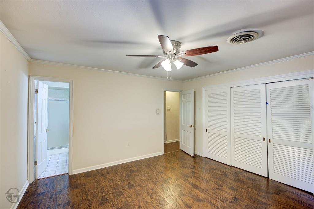 1306 East Todd Street Minden, LA 71055 - Photo 20 of 27 an empty room with wooden floor and ceiling fan