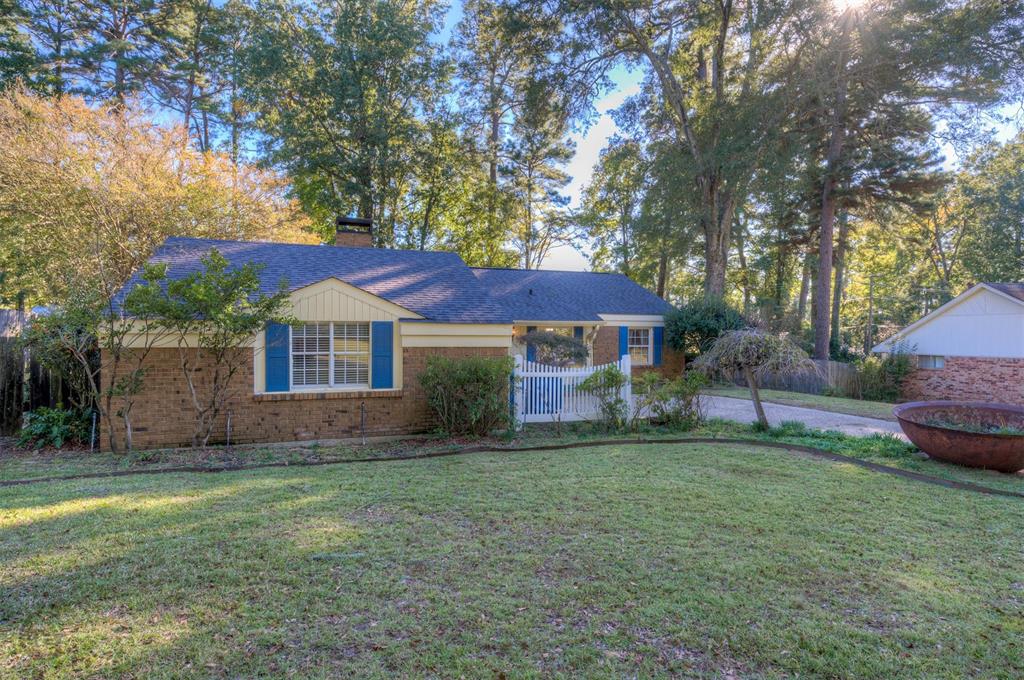 1306 East Todd Street Minden, LA 71055 - Photo 2 of 27 a view of a yard in front of a house with large trees