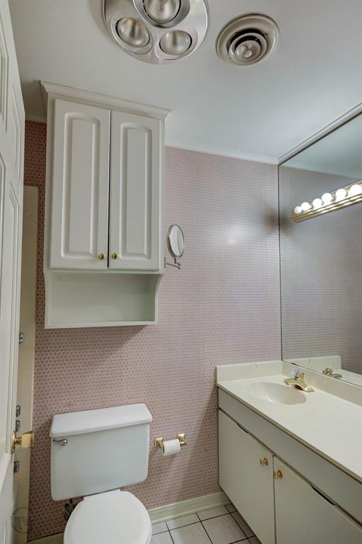 1306 East Todd Street Minden, LA 71055 - Photo 26 of 27 a bathroom with a toilet sink and mirror