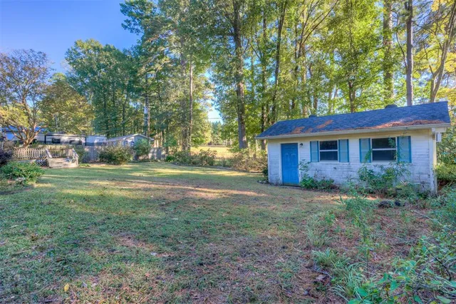 a view of a house with yard and a garden