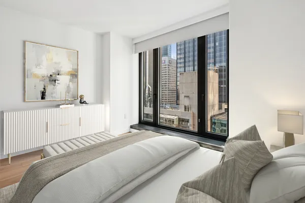 a bedroom with a large bed and a large window